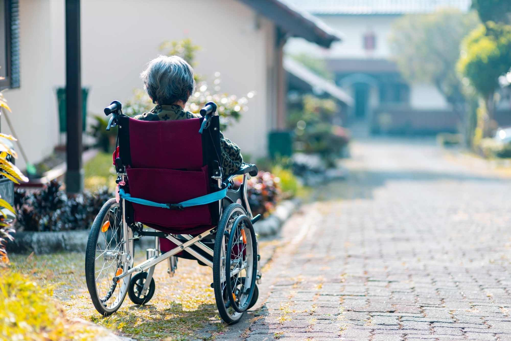 Elderly patient sitting in a wheelchair outside